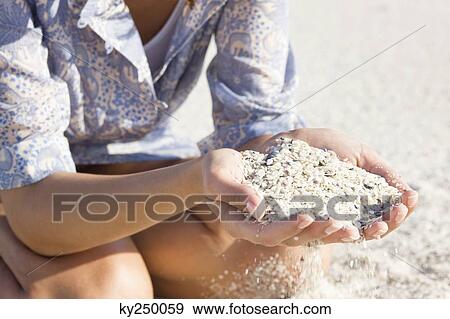 Woman playing with sand on the beach View Large Photo Image Stock Photo - Woman playing with sand on the beach. Fotosearch