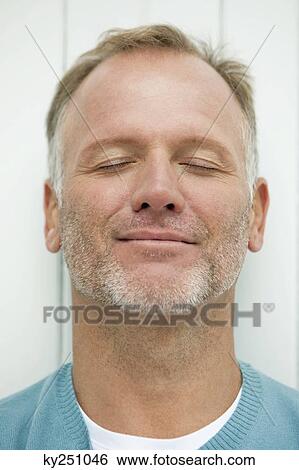 Close-up of a man day dreaming View Large Photo Image Stock Photograph - Close-up of a man day dreaming. Fotosearch