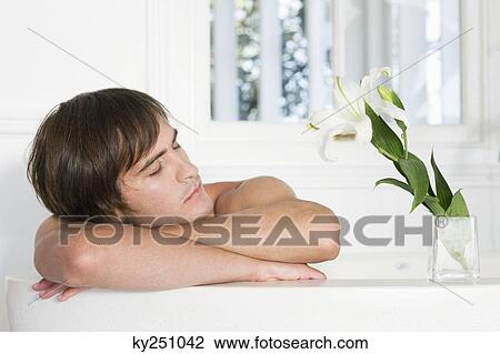 Close-up of a man in a bathtub View Large Photo Image Stock Image - Close-up of a man in a bathtub. Fotosearch