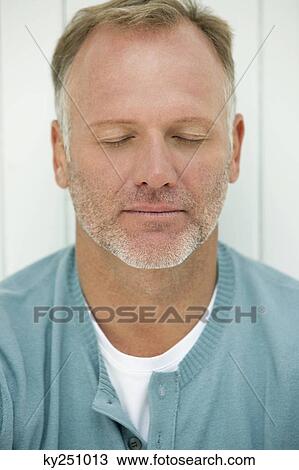 Stock Image - Close-up of a man thinking. Fotosearch