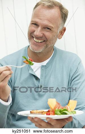 Stock Image - Man having breakfast. Fotosearch