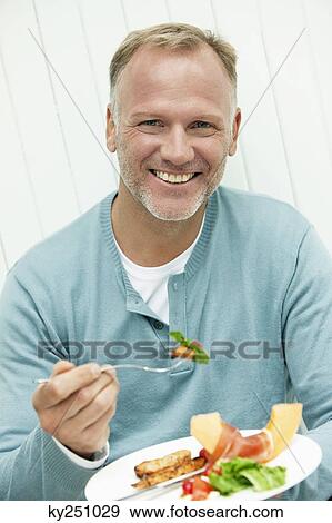 Man having breakfast View Large Photo Image Stock Photo - Man having breakfast. Fotosearch