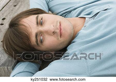 Man lying on a boardwalk View Large Photo Image Stock Image - Man lying on a boardwalk. Fotosearch