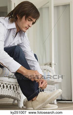 Man tying his shoelaces View Large Photo Image Stock Photo - Man tying his shoelaces. Fotosearch