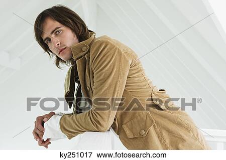 Portrait of a man leaning on the ledge View Large Photo Image Stock Photo - Portrait of a man leaning on the ledge. Fotosearch