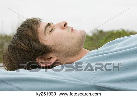 Stock Image - Side profile of a man resting. Fotosearch