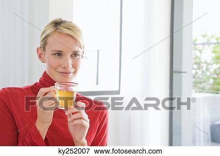 Close-up of a woman holding a cup of tea View Large Photo Image Stock Photo - Close-up of a woman holding a cup of tea. Fotosearch