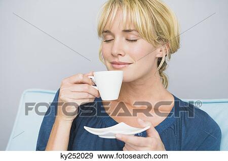 Woman holding a cup of tea View Large Photo Image Stock Photo - Woman holding a cup of tea. Fotosearch