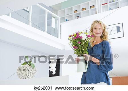 Woman holding a flower pot View Large Photo Image Stock Image - Woman holding a flower pot. Fotosearch