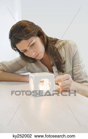 Woman lighting a candle View Large Photo Image Stock Image - Woman lighting a candle. Fotosearch