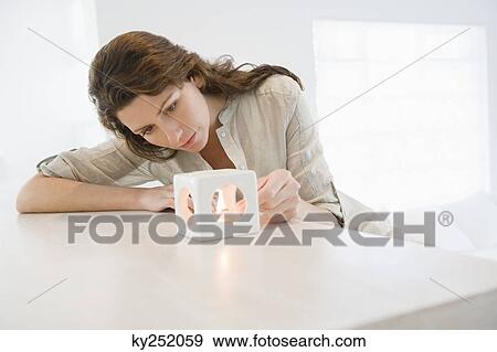 Woman lighting a candle View Large Photo Image Stock Photo - Woman lighting a candle. Fotosearch
