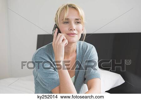 Woman talking on a mobile phone View Large Photo Image Picture - Woman talking on a mobile phone. Fotosearch