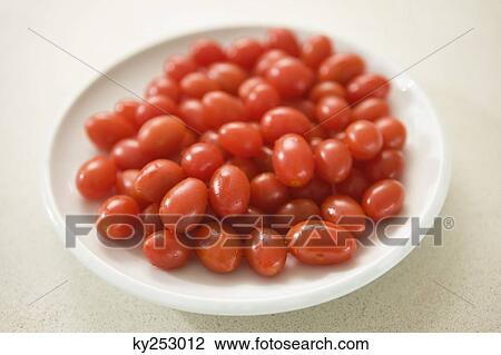 Close-up of plum tomatoes on a plate View Large Photo Image Stock Image - Close-up of plum tomatoes on a plate. Fotosearch