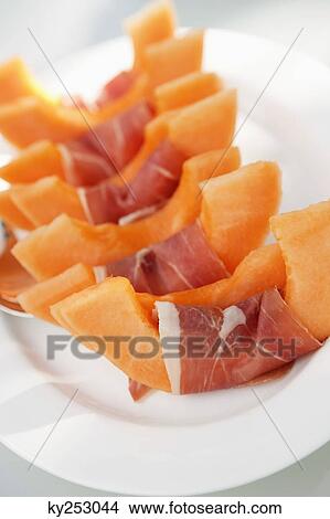 Slices of muskmelon wrapped in ham View Large Photo Image Picture - Slices of muskmelon wrapped in ham. Fotosearch