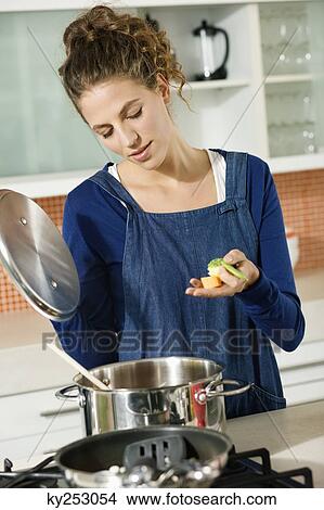 Woman preparing food in the kitchen View Large Photo Image Picture - Woman preparing food in the kitchen. Fotosearch