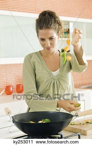 Woman preparing food in the kitchen View Large Photo Image Stock Image - Woman preparing food in the kitchen. Fotosearch