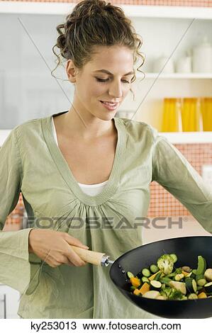 Woman preparing food in the kitchen View Large Photo Image Stock Image - Woman preparing food in the kitchen. Fotosearch