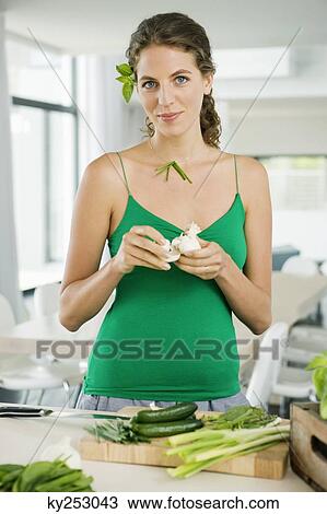 Woman preparing food in the kitchen View Large Photo Image Stock Image - Woman preparing food in the kitchen. Fotosearch
