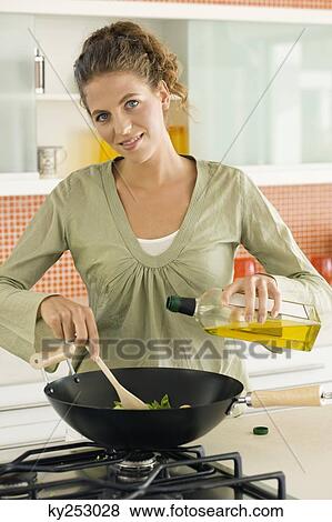 Woman preparing food in the kitchen View Large Photo Image Stock Photo - Woman preparing food in the kitchen. Fotosearch