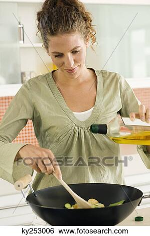 Woman preparing food in the kitchen View Large Photo Image Stock Photograph - Woman preparing food in the kitchen. Fotosearch
