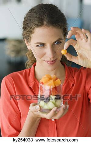 Close-up of a woman holding fruit salad View Large Photo Image Stock Image - Close-up of a woman holding fruit salad. Fotosearch