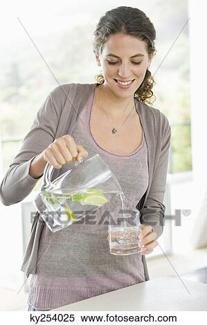 Close-up of a woman pouring lemonade View Large Photo Image Stock Photography - Close-up of a woman pouring lemonade. Fotosearch