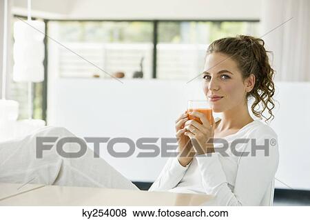 Portrait of a woman drinking tomato soup and smiling View Large Photo Image Stock Photo - Portrait of a woman drinking tomato soup and smiling. Fotosearch
