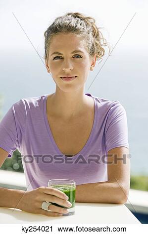 Portrait of a woman holding a glass of pea soup View Large Photo Image Stock Image - Portrait of a woman holding a glass of pea soup. Fotosearch