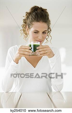 Woman holding a glass of pea soup View Large Photo Image Stock Image - Woman holding a glass of pea soup. Fotosearch