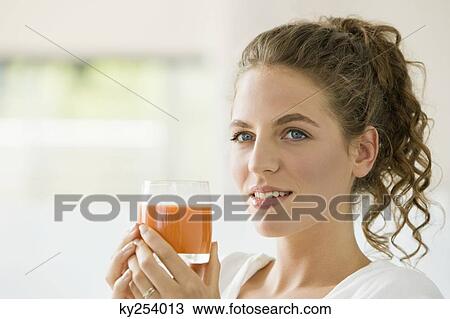 Woman holding a glass of tomato soup View Large Photo Image Stock Image - Woman holding a glass of tomato soup. Fotosearch