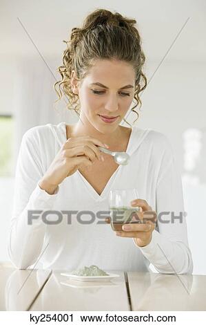 Woman mixing green clay for facial mask View Large Photo Image Stock Image - Woman mixing green clay for facial mask. Fotosearch