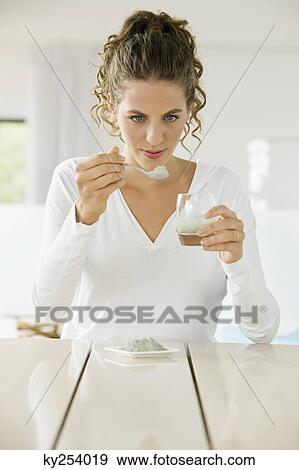 Woman mixing green clay for facial mask View Large Photo Image Stock Photo - Woman mixing green clay for facial mask. Fotosearch