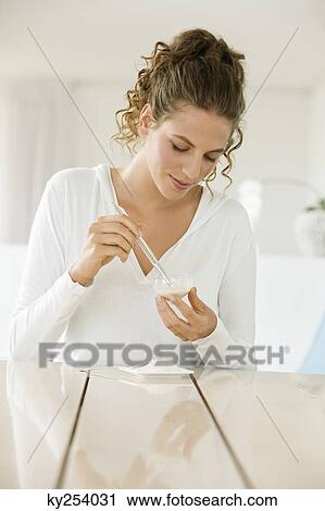 Woman mixing white clay for facial mask View Large Photo Image Stock Image - Woman mixing white clay for facial mask. Fotosearch