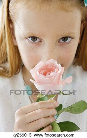 Close-up of a flower girl smelling a flower View Large Photo Image Stock Image - Close-up of a flower girl smelling a flower. Fotosearch
