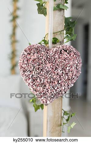 Stock Image - Close-up of heart shape decorated petals in a bedroom. Fotosearch