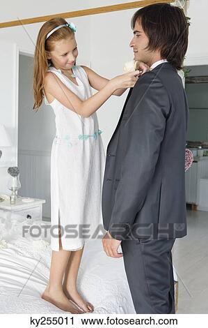 Girl adjusting groom's tie View Large Photo Image Stock Image - Girl adjusting groom's tie. Fotosearch