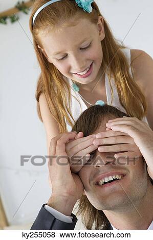 Girl covering man's eyes and smiling View Large Photo Image Stock Photo - Girl covering man's eyes and smiling. Fotosearch