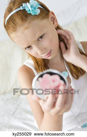 Girl holding a hand mirror View Large Photo Image Stock Photo - Girl holding a hand mirror. Fotosearch