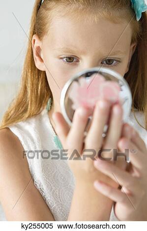 Girl holding a hand mirror View Large Photo Image Stock Photography - Girl holding a hand mirror. Fotosearch