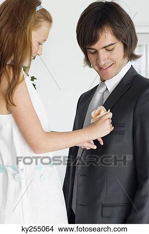 Girl pinning a corsage on a groom's tuxedo View Large Photo Image Picture - Girl pinning a corsage on a groom's tuxedo. Fotosearch
