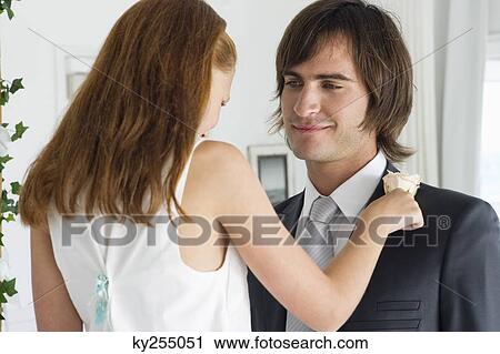 Girl pinning a corsage on a groom's tuxedo View Large Photo Image Stock Image - Girl pinning a corsage on a groom's tuxedo. Fotosearch