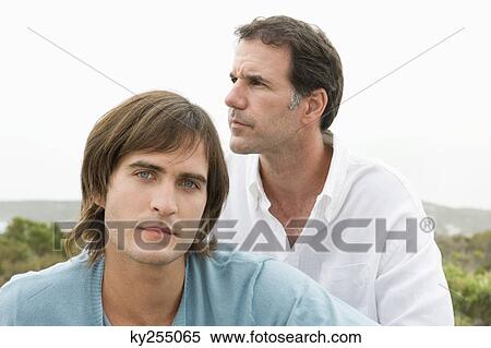 Stock Photography - Two men sitting together and thinking. Fotosearch