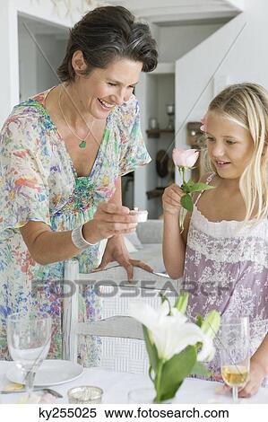 Woman arranging a table for a party with her daughter View Large Photo Image Stock Photography - Woman arranging a table for a party with her daughter. Fotosearch