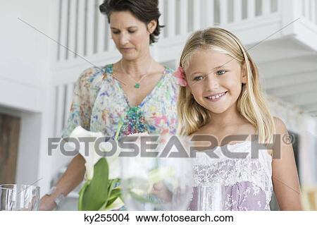 Woman with her daughter preparing for a party View Large Photo Image Picture - Woman with her daughter preparing for a party. Fotosearch