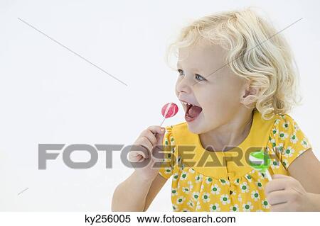 Girl eating two lollipops View Large Photo Image Stock Photography - Girl eating two lollipops. Fotosearch
