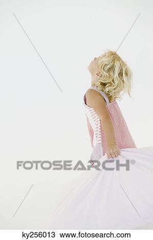 Stock Image - Girl holding a cloth and looking up. Fotosearch