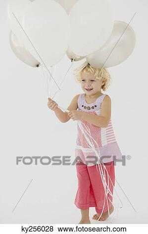Girl holding balloons View Large Photo Image Stock Photo - Girl holding balloons. Fotosearch