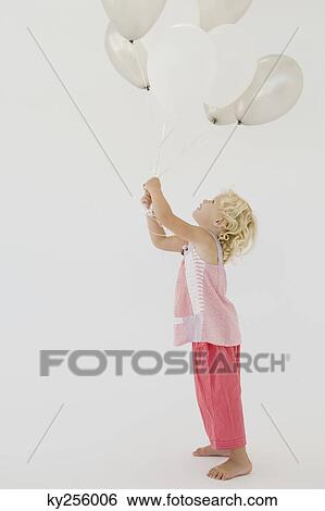 Girl holding balloons View Large Photo Image Stock Photograph - Girl holding balloons. Fotosearch