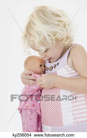 Girl hugging a doll View Large Photo Image Picture - Girl hugging a doll. Fotosearch