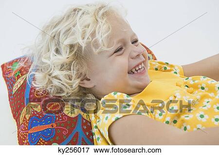 Girl lying and smiling View Large Photo Image Stock Photo - Girl lying and smiling. Fotosearch